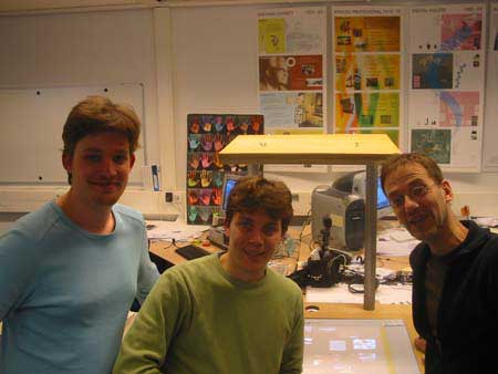 sticker 5: A picture of the proud Cabinet development team, from left to right Aldo Hoeben, Ianus Keller and Aadjan van der Helm, posing before the officially finished prototype.    This was a day before it was going to be sent out to practice and we needed a way to commemorate this moment.    This picture was taken on February 4, 2004 by Gert Pasman using my digital camera.    On flickr.com/photos/cabinet/sets/ are more pictures of the development team (people) and of the history of Cabinet